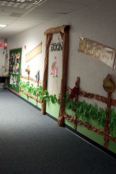 an office hallway decorated with paper machs and fake grass on the wall, as well as decorations