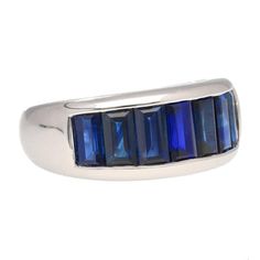 18k solid white gold sets this stunning natural baguette cut Blue Sapphire ring. The sapphires are channel tension set, with a seamless design that offers a glorious hall of mirrors effect when worn on the finger. Each sapphire features a vivid blue color saturation and excellent luster. The channel mounting has a graduated setting, where the stones increase in size as you reach the center.   The smooth edges add a wonderful texture that glides on the finger like butter.   Item Details: - Type: Modern Blue Rings With Baguette Diamonds, Modern Silver Sapphire Ring With Baguette Cut, Modern Silver Baguette-cut Sapphire Ring, Modern Sapphire Baguette Cut Ring For Formal Occasions, Modern Baguette Cut Sapphire Ring, Modern Blue Baguette Cut Ring, Blue Sapphire Ring With Channel Set Baguette Cut, Blue Sapphire Baguette Cut Channel Set Ring, Blue Sapphire Baguette Cut Ring Channel Set