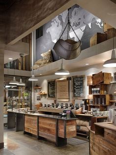 the interior of a restaurant with lots of counter space and hanging lights on the ceiling