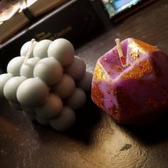 an apple and some marshmallows are sitting on a table next to books