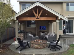 an outdoor living area with chairs and a fire pit