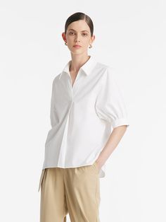 -Classic and elegant   -V-neck design   -With a silk scarf   This shirt exudes timeless elegance with its loose-fitting style and refined details. The puff sleeves add a touch of femininity, while the tapered cuffs provide a subtle contrast with their understated simplicity. The V-neck design enhances the neckline. Its clean lines and minimalist design epitomize classic sophistication, making it a versatile piece for various occasions. The shirt comes with a luxurious silk scarf, allowing for en Classic V-neck Blouse With Relaxed Fit, Chic Workwear Shirt With Balloon Sleeves, Elegant V-neck Top With Cuffed Sleeves, Classic V-neck Relaxed Fit Blouse, Chic Puff Sleeve Shirt With Cuffed Sleeves, Elegant V-neck Shirt For Daywear, Classic Tops For Workwear With Balloon Sleeves, Formal Tops With Puff Sleeves And Cuffed Details, Classic Workwear Top With Balloon Sleeves