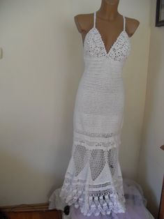 a white crochet dress is displayed on a mannequin