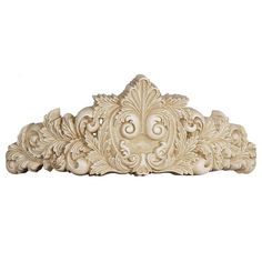 an intricately carved wall panel with flowers and leaves on it's sides, in white