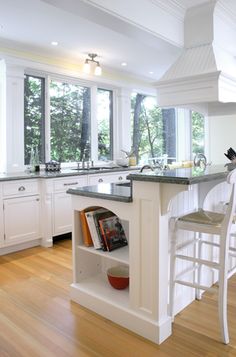 a kitchen with white cabinets and an island