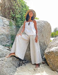 "Wide Leg Pants, White Summer Pants, Boho Pants Beautiful flare pants made with very soft double gauze cotton with stripe pattern Sizing: Made in one size to fit XS to XL / US: 2/4/6/8/10/12/14/16 Measurement; Elastic waist 23\"- 48\" Hip max 50\" Rise 11.5\" Length outseam 36\" Length inseam 24\" **Model is a size US 6. 5'4\" Tall** Description: Made with 100% soft double gauze cotton. The fabric is super soft and has a black stripe pattern. Medium-thick, breathable, and not a see-through. Elas White Summer Pants, Bloomer Pants, Wide Leg Pants White, Oversize Pants, Natural Clothing, Hippie Pants, Boho Pants, Pants Loose, Pants White