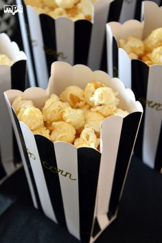 some black and white striped paper bags filled with popcorn