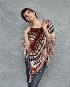 Crochet poncho in browns, Alpaca poncho wrap, Boho poncho in earth tones, Crochet cover-up. This crochet alpaca fringe poncho in earth tones is very soft and gentle. Poncho is lightweight and it's made of soft yarn - a blend of alpaca and silk, that's why it is very fluffy and soft to the touch. It will be the perfect accessory for spring and fall or even cool summer nights.  Size M/L Color: ecru and various shades of browns. Because of different monitors and screen resolutions, color may look different on the screen than in reality. If you want such poncho in any other color and size please feel free to contact me. I will be happy to make it for you. Care instructions: Hand washes in lukewarm water (30o C). Dry flat. Fall Festival Poncho Shawl, Fall Festival Shawl Poncho, Bohemian Shawl Poncho For Fall, Brown Fringed Poncho For Fall, Brown Fringe Poncho For Fall, Hippie Poncho For Fall, Bohemian Shawl Cape For Fall, Hippie Fall Poncho One Size, Hippie One-size Poncho For Fall