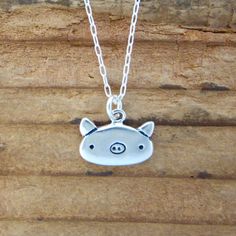 "This cute little pig necklace is made from sterling silver and measures about 1/2 of an inch tall and wide. Shipped as the charm only or on your choice of silver-plated or sterling silver cable chain in either 16\", 18\", or 20\". Please use the drop down menu for your options. To see the matching earrings go here: https://www.etsy.com/listing/551264706/pig-earrings-sterling-silver-pig?ga_search_query=pigs&ref=shop_items_search_8 To see all my little charms go here: https://www.etsy.com/sho Cute Sterling Silver Pendant Charm Necklaces, Cute Sterling Silver Pendant Charm Necklace, Cute Silver Sterling Silver Charm Necklaces, Cute Nickel-free Sterling Silver Necklaces, Cute Hypoallergenic Silver Charm Necklaces, Cute Silver Jewelry With Adjustable Chain, Cute Nickel-free Silver Charm Necklace, Cute Nickel-free Sterling Silver Jewelry, Cute Sterling Silver Nickel-free Jewelry