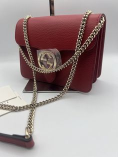 Gucci GG Dollar Calf Red Interlocking Chain Handbag Leather Bag Italy 510304. Gucci Gucci GG Dollar Calf Red Interlocking Chain Handbag Leather Bag Made in Italy NEW Dustbag Shoulder Bag Italy Authentic New New with Tags. Made in Italy. ONLY 1 in stock Red bags are so very in this season!!! Approx Base Length: 7.5” Height: 5.5” Width: 3.5” Shoulder Drop: 11” and 22.25” Can be worn as a shoulder bag or a crossbody. Dollar Calfskin Medium Interlocking G Shoulder Bag A Gucci handbag can be instantly-recognized anywhere, any time. Thanks to the brand’s pioneering Creative Director, the Florentine fashion house has become one of the world’s most influential names. This red leather GG ring shoulder bag from Gucci features gold-tone hardware, an adjustable shoulder strap, a hanging Double G ring Luxury Red Bag With Lock, Elegant Red Bags With Lock, Red Top Handle Bag With Lock, Classic Gucci Shoulder Bag With Chain Strap, Gucci Classic Shoulder Bag With Chain Strap, Red Gucci Bag With Chain Strap, Gucci Red Evening Bag, Elegant Gucci Bag With Chain Strap, Red Gucci Evening Bag