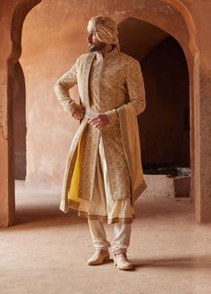 Editor's Note Radiate regal charm in our gold raw silk sherwani, meticulously adorned all over with tonal resham, kasab, dabka, and beadwork. Accompanied by a beige monga tussar kalidar kurta and churidar, this ensemble is a perfect blend of opulence and tradition. With its captivating craftsmanship and luxurious fabric, it's a choice that ensures you stand out on your special occasion. Note: Stole and belt are for styling purposes only. Fabric: Raw silk and monga tussar Color: Gold Components: Embroidered Sherwani, Groom Fashion, Sherwani Groom, Wedding Sherwani, Indian Groom, Mens Luxury Fashion, Kurta With Pants, Silk Organza, Wedding Outfits