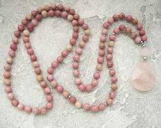 Rhodochrosite Mala Necklace for Women Pinck Beads Long Necklace Rose Quartz Mala Necklace Yoga Jewelry Yoga Gift for Mum Meditation Necklace - 8mm Natural Rhodochrosite Beads - 12mm Rose Quartz Guru Crystal Bead - Rose Quartz Pendant - Neylon Cord ♥ ♥ ♥ ROSE QUARTZ ♥ ♥ ♥ Rose Quartz Crystal is a quartz crystal that derives its name from its lovely rose pink color. These crystals come in a range of beautiful shades of pink. It is known as the 'love stone' as the message it emits is the strong vib Pink Beaded Necklaces With Natural Stones As Gift, Pink Beaded Necklace With Natural Stones For Gift, Spiritual Pink Beaded Necklaces With Natural Stones, Pink Natural Stones Beaded Necklace For Healing, Pink Hand-strung Necklace As Gift, Pink Hand-strung Necklace For Gift, Pink Spiritual Beaded Necklace For Gift, Bohemian Pink Necklace With Polished Beads, Pink Round Beads Necklaces For Meditation