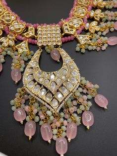 This adjustable long necklace is a very unique and fun piece for any event. The neutral gold and pastel pinks with polki work makes this the perfect statement set to wear! Comes with a matching pair of earrings Kundan Long Necklace For Party, Long Kundan Necklace For Party, Pink Necklaces With Tilla For Diwali, Pink Tilla Necklaces For Diwali, Party Long Kundan Necklace, Pink Hand Set Temple Jewelry Necklace, Pink Tilla Necklace For Diwali, Pink Meenakari Necklaces For Festivals, Pink Meenakari Necklace For Festivals