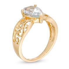 She'll be proud to wear this ravishing gemstone ring. Crafted in warm 10K gold, this unforgettable design showcases a 10.0 x 7.0mm pear-shaped icy-blue aquamarine solitaire centered on a sculpted filigree-detailed shank. Buffed to a brilliant luster, this ring is a fabulous choice she won't be able to resist. Elegant Pear-shaped Yellow Gold Birthstone Ring, Formal Yellow Gold Topaz Teardrop Ring, Yellow Gold Pear-shaped Ring With Accent Stones, Elegant Pear Shaped Gemstone Rings, Pear-shaped Yellow Gold Rings With Accent Stones, Pear Shaped Yellow Gold Rings With Accent Stones, Anniversary Yellow Gold Teardrop Topaz Ring, Elegant Yellow Gold Pear-shaped Topaz Ring, Elegant Pear-shaped Yellow Gold Topaz Ring