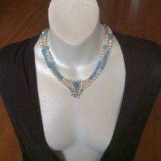 This combo style spiritual necklace handmade with round Aquamarine and Pearl beads. It will be a nice gift for sophisticated fashion and/or jewelry lover.  Our pictures show how we could wear this Blue and Pearl beautiful combo necklace.  By its metaphysical meaning, Aquamarine increases leadership abilities. Pearl is known as a nature wisdom creature. Each Pearl is unique, it absorbs and holds different inspirational thoughts, and the energy of one bead doesn't blend with the energy of another. All kinds of the natural Pearls balance and heal all chakras. Handmade Double Strand Pearl Necklace, Elegant Handmade Double Strand Crystal Necklaces, Elegant Handmade Double Strand Crystal Necklace, Multi-strand Pearl Necklace With Natural Stones For Gifts, Gift Multi-strand Pearl Necklace With Natural Stones, Bohemian Double Strand Pearl Necklace Gift, Elegant Multi-strand Crystal Necklace For Gift, Spiritual Healing Double Strand Crystal Necklaces, Spiritual Double Strand Gemstone Beads Necklace