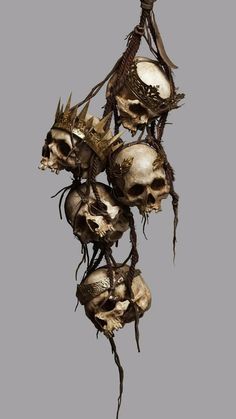 a bunch of skulls that are hanging from a hook in the air with strings attached to them