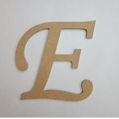 the letter f is cut out from cardboard and placed on a white surface with scissors