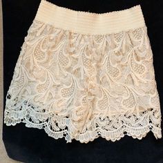 These Cute Cream-Colored Shorts Boast A Stretch Waist And Are Fully Lined In Size Medium. Short Lace Bottoms For Spring, Chic Short Length Lace Shorts, Summer Lace Short Length Bottoms, Casual Lace Beige Bottoms, Summer Lace Short Bottoms, Short Length Bottoms With Lace Trim For Day Out, Short Lace Trim Bottoms For Day Out, Casual Lace Short Bottoms, Casual Short Lace Bottoms