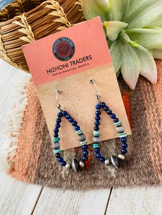 New without tags BRAND : Nizhoni Traders LLC JEWELRY TYPE : Earrings TYPE : Earrings STYLE : Dangle METAL : Sterling Silver MAIN STONE : Lapis Lovely Handmade Turquoise, Lapis and Sterling Silver Beaded Dangle Hoop Earrings. Such beautiful craftsmanship! These measure 2 1/4 inches long and 1 inch wide. Stones are natural and will vary. Thank you for checking out my store. Please contact us with any questions. 4/25/23 bin 28 Artisan Blue Earrings With Dangling Beads, Artisan Natural Stone Beaded Dangle Earrings, Artisan Dangle Beaded Earrings With Natural Stones, Artisan Natural Stone Dangle Beaded Earrings, Artisan Beaded Dangle Earrings With Natural Stones, Southwestern Dangle Hoop Earrings As Gift, Southwestern Style Dangle Hoop Earrings As Gift, Artisan Drop Earrings With Dangling Beads, Bohemian Blue Beaded Earrings With Natural Stones