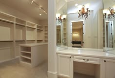 an empty walk in closet with mirrors and lights