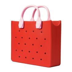 a red bag with pink handles and holes on the front, sitting against a white background