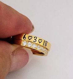 "This is a super shiny 14 Kt Gold Plated over Stainless Steel 3 mm wide ring. Stack them! 2 or 3 rings are comfortable to wear. Wear as a band with other rings. Great alternative for a wedding band with your diamond. Makes an awesome thumb ring also. This ring is also available in Silver Stainless steel, Rose Gold and as 3 pc. sets with the gold CZ Stainless steel NEVER rusts, tarnishes turns your finger green and is hypoallergenic. I hand stamp each letter than use the best quality jewelry pain Customized Nameplate Rings For Anniversary, Custom Nameplate Rings For Promise, Custom Nameplate Ring For Promise, Custom Name Nameplate Ring For Promise, Hand Stamped Yellow Gold Engraved Ring For Anniversary, Anniversary Yellow Gold Hand Stamped Engraved Ring, Customizable Nameplate Promise Ring, Adjustable Personalized Gold Stackable Rings, Personalized Initial Ring For Promise With Round Band