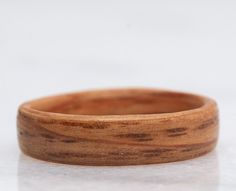 a wooden ring sitting on top of a white surface