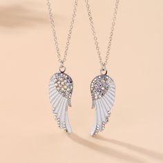 Surprise your best friend with this stunning Angel Wings Matching Best Friend Necklaces Gift Set! Made with high-quality alloy and sparkling cubic zirconia, these necklaces are a symbol of your special bond. Each necklace is 55cm long and comes with a complimentary gift box and card. Show your friendship in a meaningful and stylish way! Materia: Alloy + Cubic Zirconia Length: 55cm ~ 21Inch Package Includes: Pair of Jewelry as shown in main picture + 1 x Complimentary Gift Box and a Gift Card Rhinestone Alloy Necklaces As Gifts, Rhinestone Alloy Necklace As Gift, Rhinestone Alloy Necklace For Gifting, Rhinestone Alloy Necklace For Gift, Silver Clavicle Chain Necklace For Friendship, White Pendant Necklace With Rhinestones, Diamond White Rhinestone Necklace Gift, Diamond White Rhinestone Necklace As Gift, White Alloy Jewelry For Anniversary