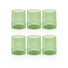 six green glass tumblers sitting next to each other