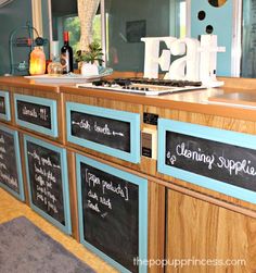 a kitchen with blue cabinets and chalk writing on the counter