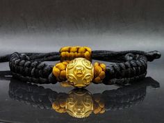 Gift yourself or your love once this Unisex Money Ball Bracelet. Crafted with 24 Karat Gold amd Mandala String. *Karat: Au999 Pure Gold *Gold Color: Yellow *Gold Weight; 1.63grams *LENGTH: Adjustable *Band Width: 10.4mm *Money Ball Size: 14.1mm *Real 24K Gold. NOT gold filled. NOT gold Plated. Pls message us if you want to customize your bracelet a certain way and we'll be happy to help you 💥PLS FOLLOW US AND CHECK OUR OTHER LISTINGS. WE HAVE NEW STOCKS LISTED DAILY/WEEKLY. 📬S H I P P I N G WE Handmade Adjustable Traditional Gold Bracelet, Handmade Traditional Gold Bracelet, Traditional Handmade Adjustable Gold Bracelet, Gold Spiritual Wristband With Round Beads, Gold Adjustable Spiritual Wristband, Adjustable Gold Spiritual Wristband, Adjustable Gold Bracelet Wristband, Adjustable Gold Wristband With Round Beads, Traditional Adjustable Gold Bracelet Gift