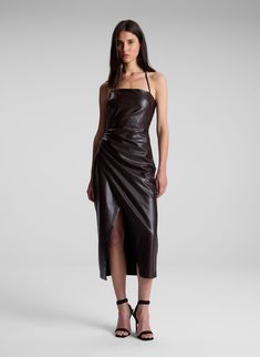 The Charlotte Dress is crafted from vegan leather in a chocolate plum hue, featuring an incredibly flexible yet structured feel. This midi silhouette features a straight, adjustable halter neckline and asymmetrical pleating through the bodice with a faux-wrap effect. Shop Dresses. Styling Tip: Pair with simple heeled sandals and a raffia clutch for warm-weather occasions. Brown Halter Neck Midi Dress For Party, Raffia Clutch, Leather Midi Dress, Charlotte Dress, Halter Neckline, Heeled Sandals, Shop Dresses, Warm Weather, Best Sellers