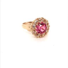 Vintage 1940's 10k yellow gold pink stone ring. The center stone is the color of a gorgeous pink sapphire. The size of the ring is a 5.75, and has the ability to be resized. Classic Pink Cluster Ring For Formal Occasions, Classic Pink Ruby Ring With Halo Setting, Formal Pink Ruby Ring With Accent Stones, Pink Ruby Ring With Accent Stones For Formal Occasions, Classic Pink Cluster Ring With Prong Setting, Classic Pink Cluster Ring With Center Stone, Pink Formal Cluster Ring With Prong Setting, Pink Round Cluster Ring With Halo Setting, Pink Round Cluster Ring With Prong Setting