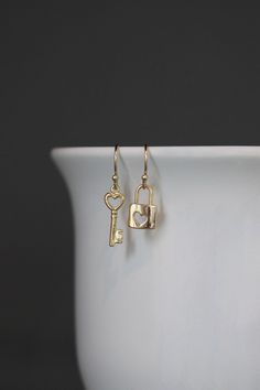 "Sweet gold vermeil heart Lock and Key charms simply dangle from gold vermeil balled earwires.  Lovely lightweight go-with-everything earrings to wear every day.  A perfect gift for someone you love! Gold Lock charm: 9x13mm Gold key charms: 6x19mm Total length of earrings: almost 1 1/4\" All gold is 18k gold vermeil A matching necklace is available... www.etsy.com/listing/1328715518/lock-and-key-necklace As the owner, maker, designer, and curator of this shop, I take great pride in providing you Lock And Key Jewelry, Heart Lock And Key, Key Heart, Key Earrings, Key Charms, Romantic Jewelry, Gold Key, Key Jewelry, Heart Lock