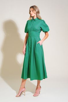 A solid woven midi dress featuring shirt collar, button down, short puff sleeve, waist yoke and full skirt Details: Self : 100% Cotton Size & Fit - Model is 5`8" And Wearing Size Small- Measurements Taken From Size Small- Approx. Length: 50" Chic Green A-line Shirt Dress, Chic Midi-length Puff Sleeve Dress With Button Closure, Chic Puff Sleeve Midi Dress With Button Closure, Elegant Short Sleeve Puff Dress With Button Closure, Elegant Button-up Puff Sleeve Dress For Spring, Elegant Puff Sleeve Button-up Dress For Spring, Elegant Spring Puff Sleeve Button-up Dress, Short Sleeve Midi Dress With Button Cuffs For Work, Chic Puff Sleeve Dress With Button Closure For Work