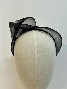 Stunning Black Crinoline Fascinator Headband. This Knotted Edgy Style Headband Fascinator has been make with Elegance in mind. Simple Design but makes a statement piece. Crinoline Fabric has been Hand knotted and Attached to a slim Satin Alice band. Very lightweight to wear. Hight is approximately 5cm Your Beautiful piece will arrive gift wrapped and packed well for shipping. Thank you for visiting my Shop If you would like a different Colour please contact me. Black Summer Wedding Headpieces, Black Structured Crown Headpiece For Weddings, Structured Crown Black Headpiece For Wedding, Adjustable Summer Ceremony Headpieces, Adjustable Wedding Headband Costume, Adjustable Mini Hat With Pinched Crown For Evening, Adjustable Headband For Ceremony, Adjustable Ceremony Headband, Fitted Evening Headband Costume