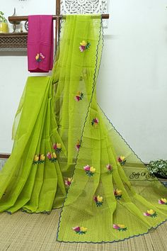 Embroidery work on green and yellow cross tone handloom resham cotton kota saree. Floral design has been neatly and densely done with multi color threads. The bright color combination and the scalloped border with all over floral motifs make this saree very elegant. this saree comes with an embroidered contrast cotton blouse piece. This saree is light weight, very comfortable & easy to drape. Details: *Fabric: Handloom Resham by cotton kota saree *Work: Machine Embroidery work [*this work is neither Computerized Machine Embroidery work nor machine Aari Embroidery with woolen thread. * It's completely Manual Machine Embroidery Work with silk threads.] *Blouse: With embroidered cotton blouse piece *Saree length: 5.5 mtrs *Saree width: 47 inches *Blouse piece length: 1 mtr *Blouse piece width Green Resham Embroidered Cotton Silk Blouse Piece, Pista Green Cotton Silk Saree With Resham Embroidery, Green Cotton Silk Dupatta With Dori Work, Embroidered Green Cotton Silk Traditional Wear, Cotton Saree With Chikankari Embroidery, Green Handloom Cotton Silk Saree, Green Cotton Silk Handloom Saree, Green Embroidered Cotton Silk Dupatta, Handloom Embroidered Cotton Saree Fabric