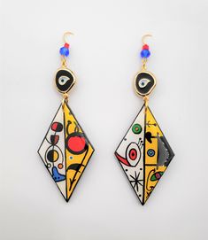 Wooden painted earrings inspired by Miro.Resin cover wooden earrings.Geometrical dangle statement earrings.Colorful inspirational women gift #WoodenEarrings #InspirationalGift #GreekEarrings #BirthdayGift #HandmadeEarrings #ResinCovered #HandmadePainting #MiróEarrings #AnniversaryGift #HandmadeJewelry Multicolor Hand Painted Drop Earrings, Artsy Enamel Drop Earrings, Hand Painted Multicolor Modern Earrings, Artistic Abstract Drop Earrings, Multicolor Artistic Drop Earrings, Artistic Abstract Design Drop Earrings, Trendy Multicolor Enamel Earrings, Multicolor Hand Painted Earrings For Art Collection, Artsy Colorful Earrings As Gift