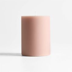 a pink candle sitting on top of a white table