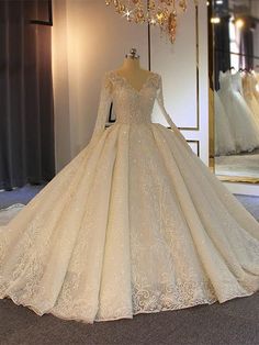 a wedding dress on display in front of a mirror