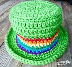 a green crocheted hat sitting on top of a wooden table