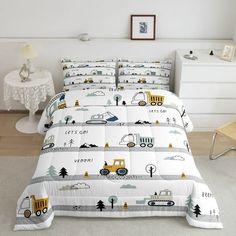 a bed with construction trucks and trees on it