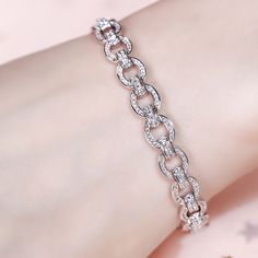 Express your creative side with the simple elegance of our chain bracelet. Crafted in sterling silver, the stylish piece gives your look a playful edge that lets you tell your story in your own unique way. Discover the complete selection of our classic chain bracelet for women.Carat Weight: 4.068 ctStone Size: 1.5,1.1,0.9 mmNumber of Stones: 344 Stone Shape: RoundStone Color: Diamond WhiteWeight: 13.52 gWidth: 8.5 mmHeight: 4.8 mmThickness: 7 mmMaterial: Stone Type: Jeulia® StonePlating Color: S Elegant Sterling Silver Chain Link Bracelet With Adjustable Chain, Fine Jewelry White Gold Chain Bracelet With Adjustable Chain, Sterling Silver White Gold Diamond Chain Bracelet, Sterling Silver Diamond Bracelet With Chain In White Gold, White Gold Sterling Silver Diamond Bracelet With Chain, White Gold Diamond Bracelet With Chain In Sterling Silver, Silver Round Chain Bracelet Fine Jewelry, Silver Box Chain Bangle Bracelet, Elegant Chain Bracelet With Solid Link Construction As Gift