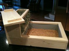 a wooden box filled with hay on top of a counter