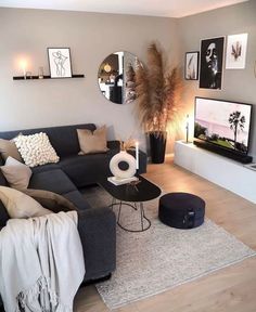 a living room filled with furniture and pictures on the wall