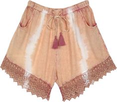 A stonewashed dusky melon rayon shorts with a decent touch of tie-dye.  These shorts feature a beautiful crochet lace at the bottom to enhance the bohemian look and cute drawstring tassels in a complementing color. #tlb #Pocket #Yoga #vacationclothing #beachwrap #TieDye #bohemianfashion #BohemianShorts #TieDyeShorts #BeachShorts #CasualShorts Bohemian Summer Shorts, Bohemian Beige Shorts For Beach, Beige Bohemian Shorts For Vacation, Summer Festival Bottoms With Crochet Trim, Bohemian Shorts For Spring, Spring Bohemian Shorts, Bohemian Bottoms With Crochet Trim For Summer, Bohemian Summer Bottoms With Crochet Trim, Bohemian Vacation Bottoms With Crochet Trim