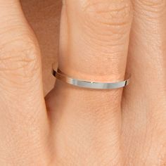 a woman's hand with a silver ring on her left side and the other half of her finger