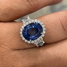 An enviable jewel, this ring sports some dazzling Diamonds & a sparkling Sapphire. Gemstones Type: Sapphire Gemstones Shape: Oval Gemstones Weight: 5.92 ctGemstones Color: Blue Diamonds Shape: Round & Radiant Side Diamonds Weight: 1.75 ct Side Diamond Color: F - G Side Diamond Clarity: VS (Very Slightly Included) Metal: 18K White Gold Metal Wt: 4.3 gms Setting: Prong & Pave Finger Size: 7 To have the ring sized, please note the desired size in Special Instructions during checkout. Luxury Gia Certified Platinum Gemstones, Luxury Gia Certified Diamond Gemstones, Luxury Cluster Sapphire Ring With Center Stone, Luxury Cluster Sapphire Ring Gia Certified, Luxury Gia Certified Cluster Sapphire Ring, Luxury White Gold Gia Certified Gemstones, Luxury Gia Certified White Gold Gemstones, Luxury Gia Certified Gemstones, Luxury Gia Certified Diamond White Sapphire Ring