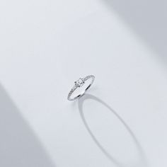 The center rose cut diamond that sits between two tapered baguettes evokes an art-deco vibe. The low profile nature of the rose cut allowed us to make an engagement ring where the diamonds all flowed into each other while hugging the finger for ultimate wearability. 14K sustainable gold Center: 0.25ct natural rose cut diamond 0.22 tcw of tapered baguette and round natural diamonds All diamonds are GH color/VS clarity Dimensions: Band Width 2.0mm taperingDelivery: This item is made to order. Plea Dainty Diamond Ring For Proposal, Dainty Diamond Proposal Ring, Delicate Brilliant Cut Ring For Proposal, Promise Diamond Ring With Baguette Single Cut, Elegant Rose Cut Diamond Proposal Ring, Elegant Diamond White Rings With Rose Cut Diamonds, Cubic Zirconia Baguette Cut Diamond Ring For Proposal, Baguette Cut Cubic Zirconia Diamond Ring For Proposal, Delicate Diamond Ring With Accents