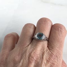 Details: Beautiful Edwardian Aquamarine 18K white gold filigree ring. This ring is very sweet, with delicately detailed filigree with tiny French fleur-de-lis . The aquamarine measures 7.3mm round. The ring is stamped 18K on the inside of the band. Measurements: Ring measures a size 6 1/2 US. It can be re-sized for a fee. Condition: The overall all condition of this ring is very good. Please ask all questions prior to placing an order. Elegant Engraved 14k White Gold Ring, Elegant Platinum Topaz Gemstone Ring, Elegant White Gold Topaz Gemstone Ring, Elegant Platinum Topaz Ring, Elegant Silver Filigree Ring In 14k White Gold, Elegant Silver-colored 14k Gold Birthstone Ring, Elegant Sapphire Ring With Intricate Design, Heirloom White Gold Topaz Ring With Center Stone, Elegant Sapphire Ring With Intricate Design For Anniversary